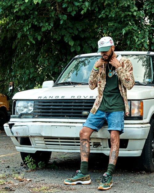 Man in Tattoos Posing near Car Outdoors