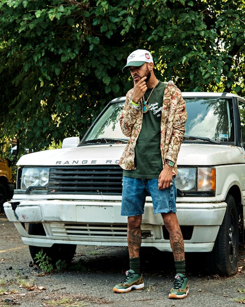 Man with Tattoos Posing near Car