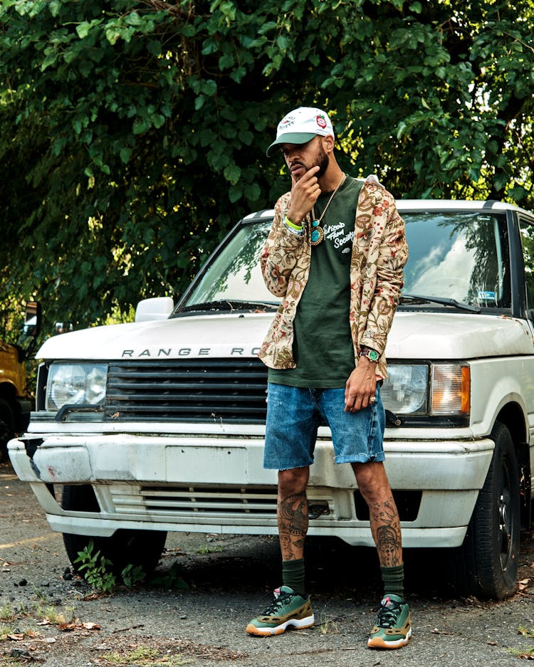 Man With Tattoos Posing Near Car