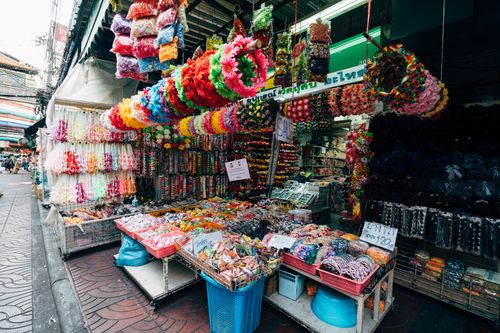Free A bustling market stall filled with colorful accessories in a lively street setting. Stock Photo
