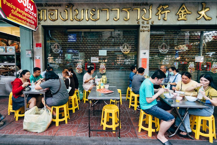 People Eating Street Food In Thai Restaurant 