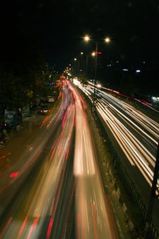 A vibrant long exposure shot capturing the dynamic motion of city traffic at night.