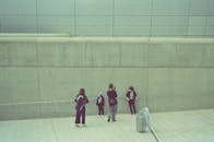 Kids Taking Photo Against Concrete Wall