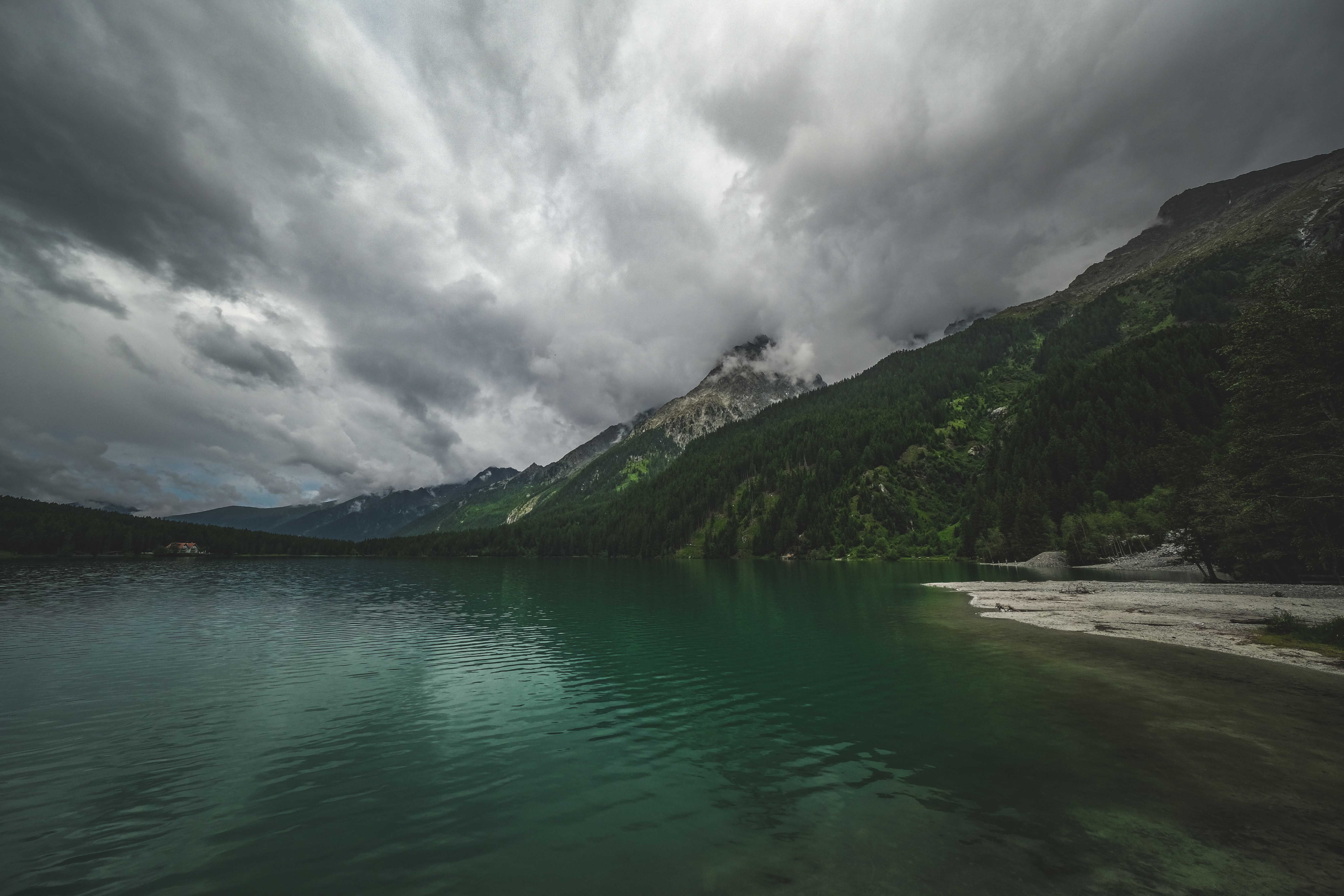 Green Lake near Mountains under the Cloudy Sky · Free Stock Photo