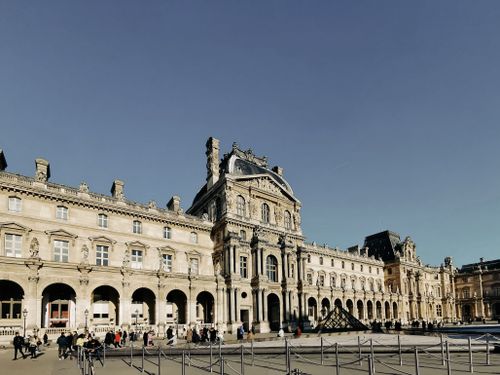 Free Beautiful exterior view of the Louvre Museum's historic architecture in Paris, showcasing its grand facade. Stock Photo
