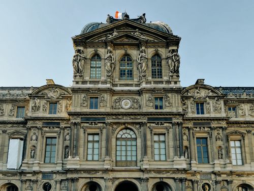 Free Stunning architectural details of the Louvre Museum in Paris, France, showcasing its historic grandeur. Stock Photo