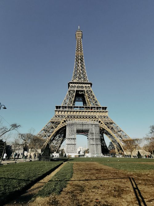 Free Iconic Eiffel Tower in Paris photographed from the front with clear blue skies. Stock Photo