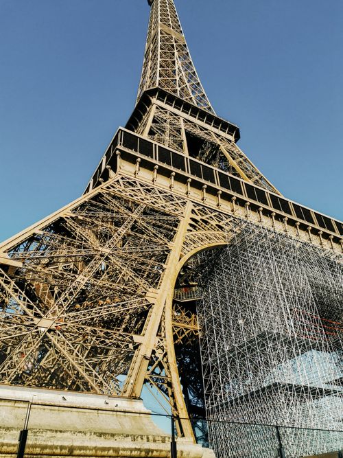 Free Low angle view of the Eiffel Tower against blue sky, Paris landmark. Stock Photo