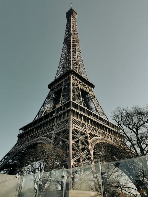 Free A breathtaking shot of the Eiffel Tower in Paris during a clear day, capturing its intricate architecture. Stock Photo