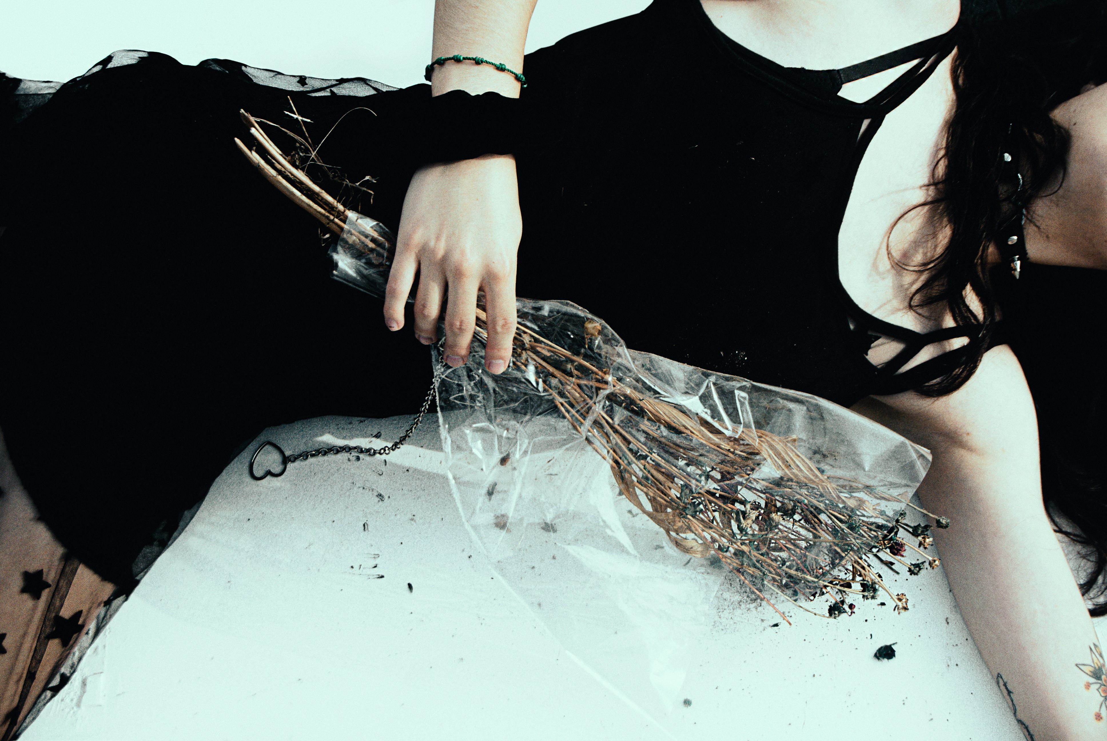Woman in Black Dress Holding Bunch of Dried Flowers with Plastic · Free ...
