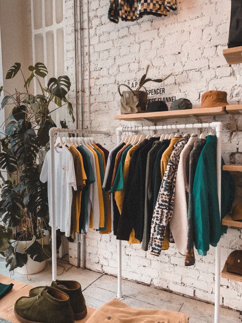 Fashionable interior of a modern boutique in Birmingham, England with vintage clothing and chic decor.