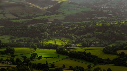 Free Stunning aerial view of a lush green countryside with fields and valleys. Stock Photo