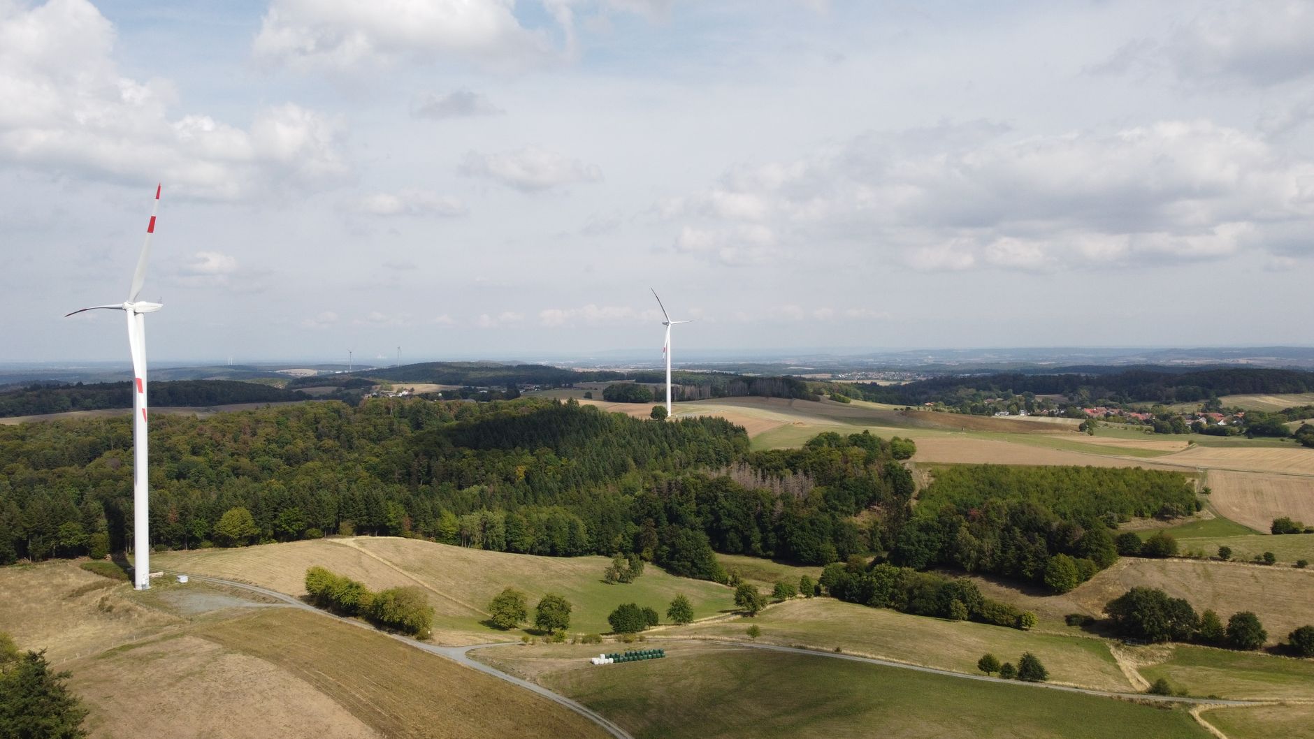 Aerial view of wind turbines and lush fields in Seeheim-Jugenheim, Germany.