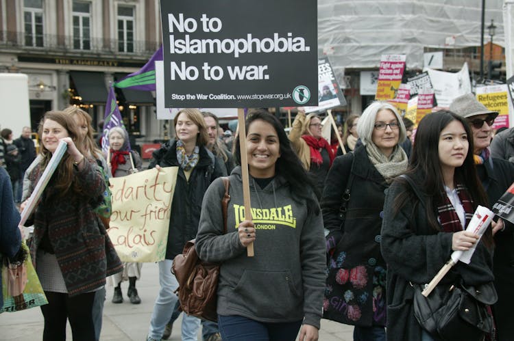 Smiling Women Protesting With Signs