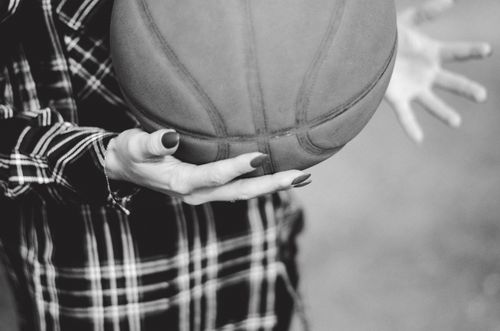 Free Monochrome image of hands holding a basketball, emphasizing texture and motion. Stock Photo