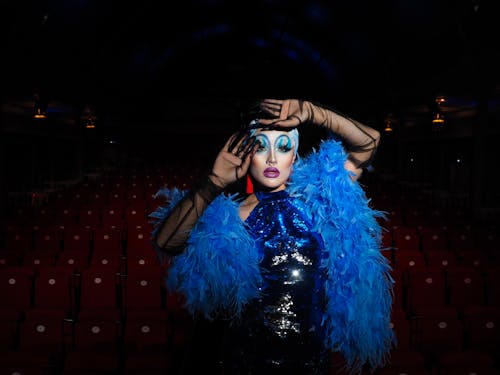 Woman in Eccentric Costume Posing in Theater 