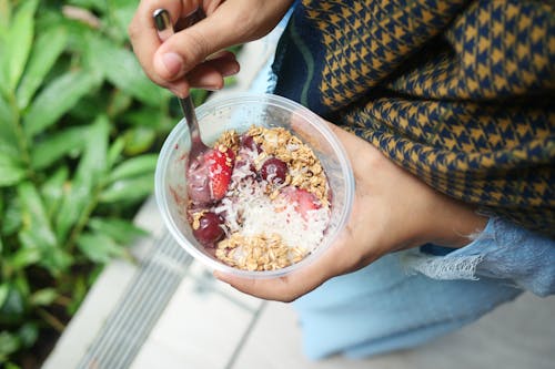 Free A Person Holding Cereals in a Plastic Container Stock Photo