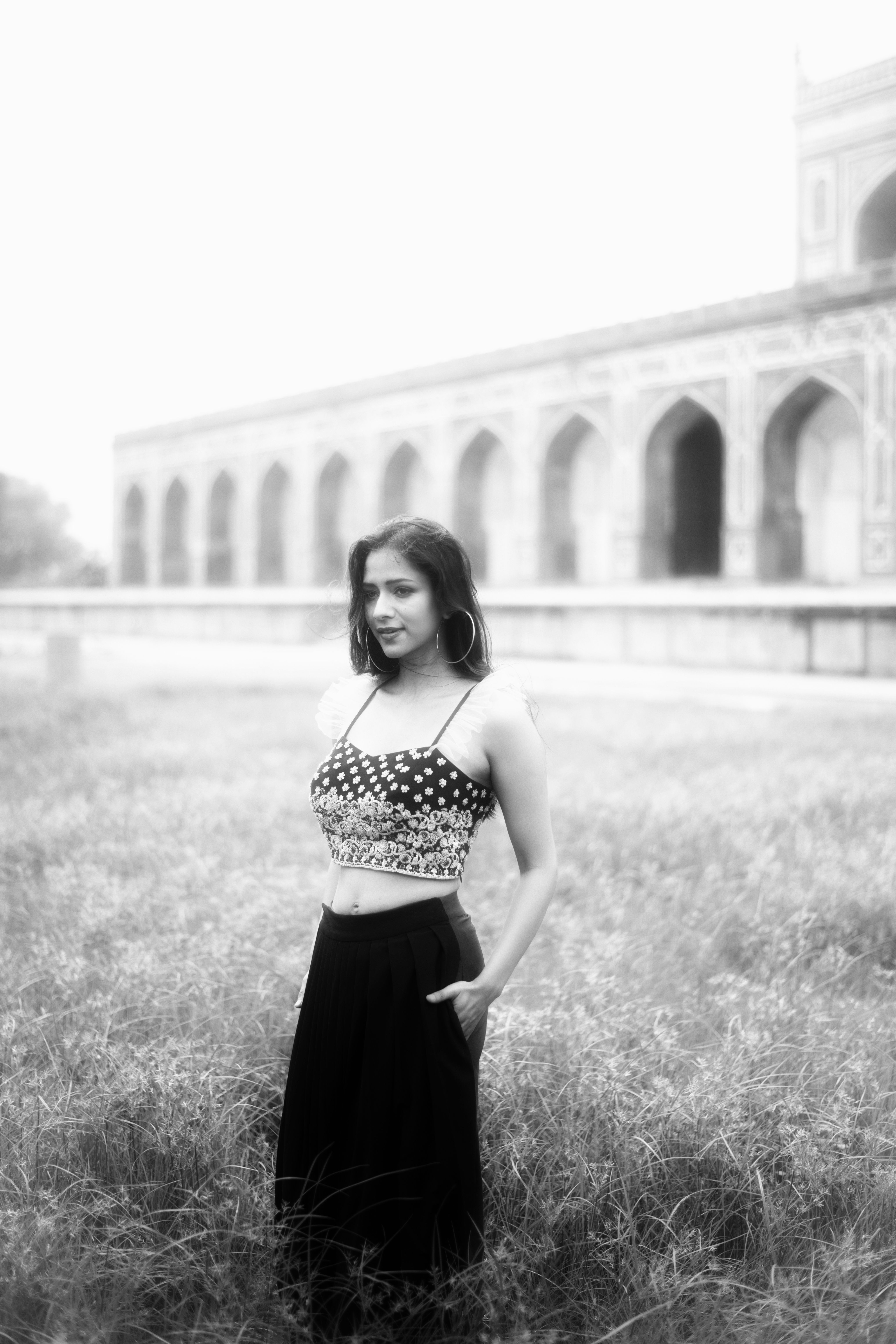 Grayscale Photo of a Woman on a Grassy Field · Free Stock Photo