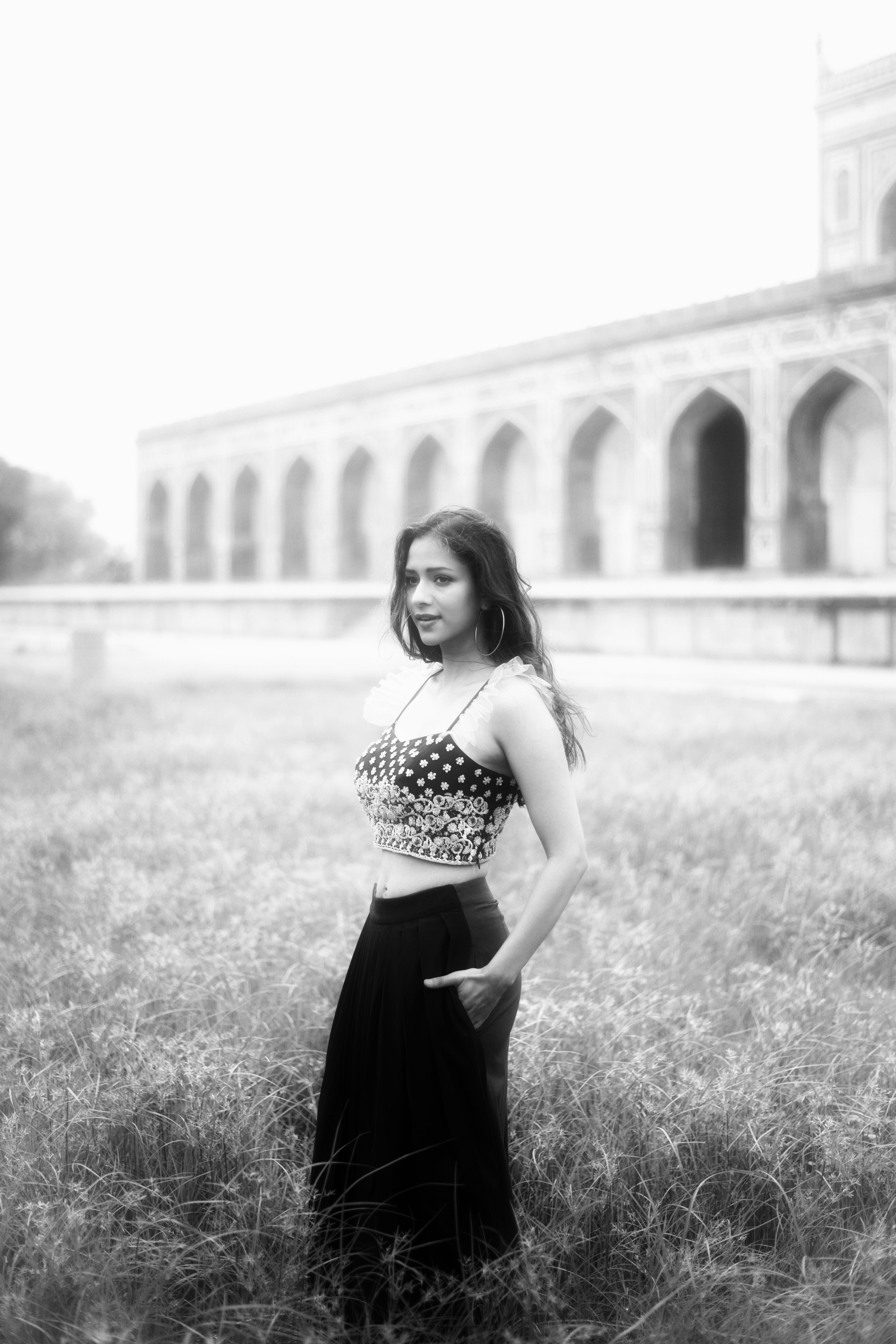 Grayscale Photo of a Woman on a Grassy Field · Free Stock Photo