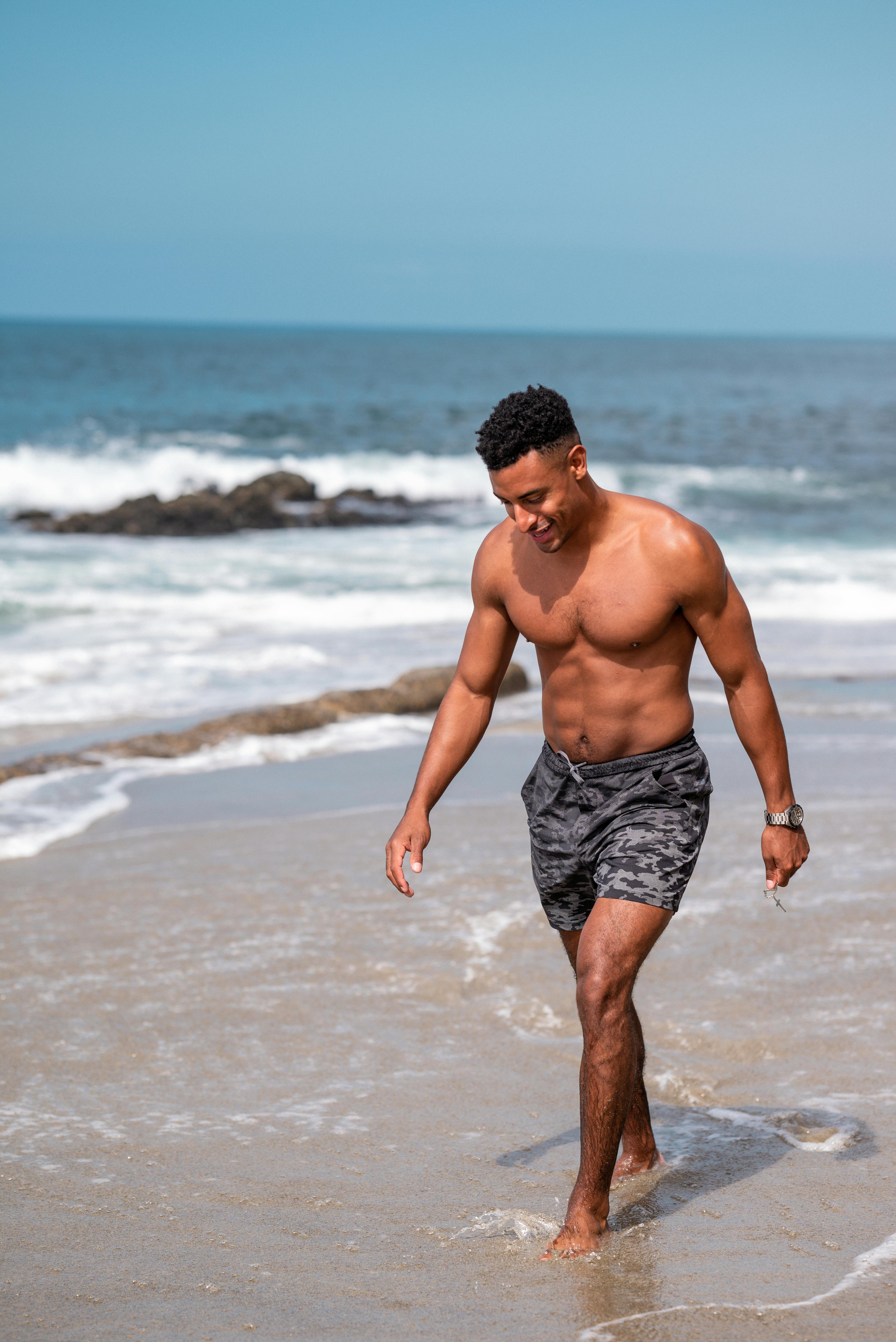 Topless Man Walking on the Beach · Free Stock Photo