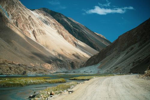 Free Explore the serene beauty of rugged mountains and pristine river valley under a clear blue sky. Stock Photo