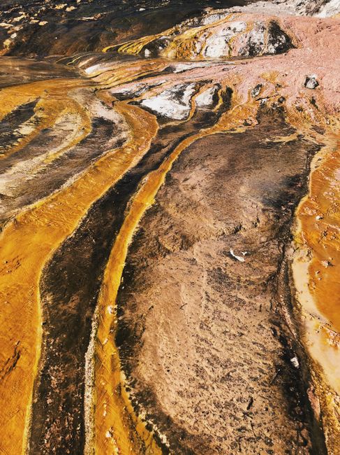 A striking geothermal formation in Mihi, Waikato, New Zealand, showcasing vibrant mineral deposits and textures.