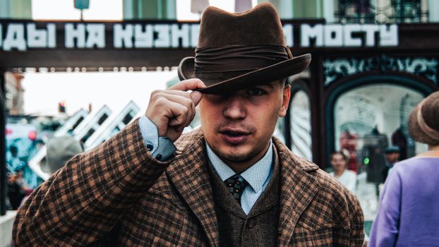 Man in Brown and Black Plaid Button Up Shirt Wearing Brown Cowboy Hat