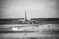 Grayscale Photo of Airplane at the Airport