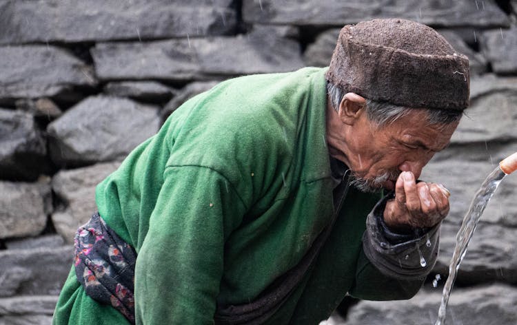 Old Man Drinking Water Outdoors