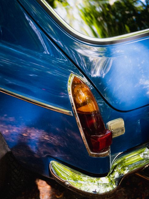 Detailed shot of vintage car's tail light with vibrant reflections.