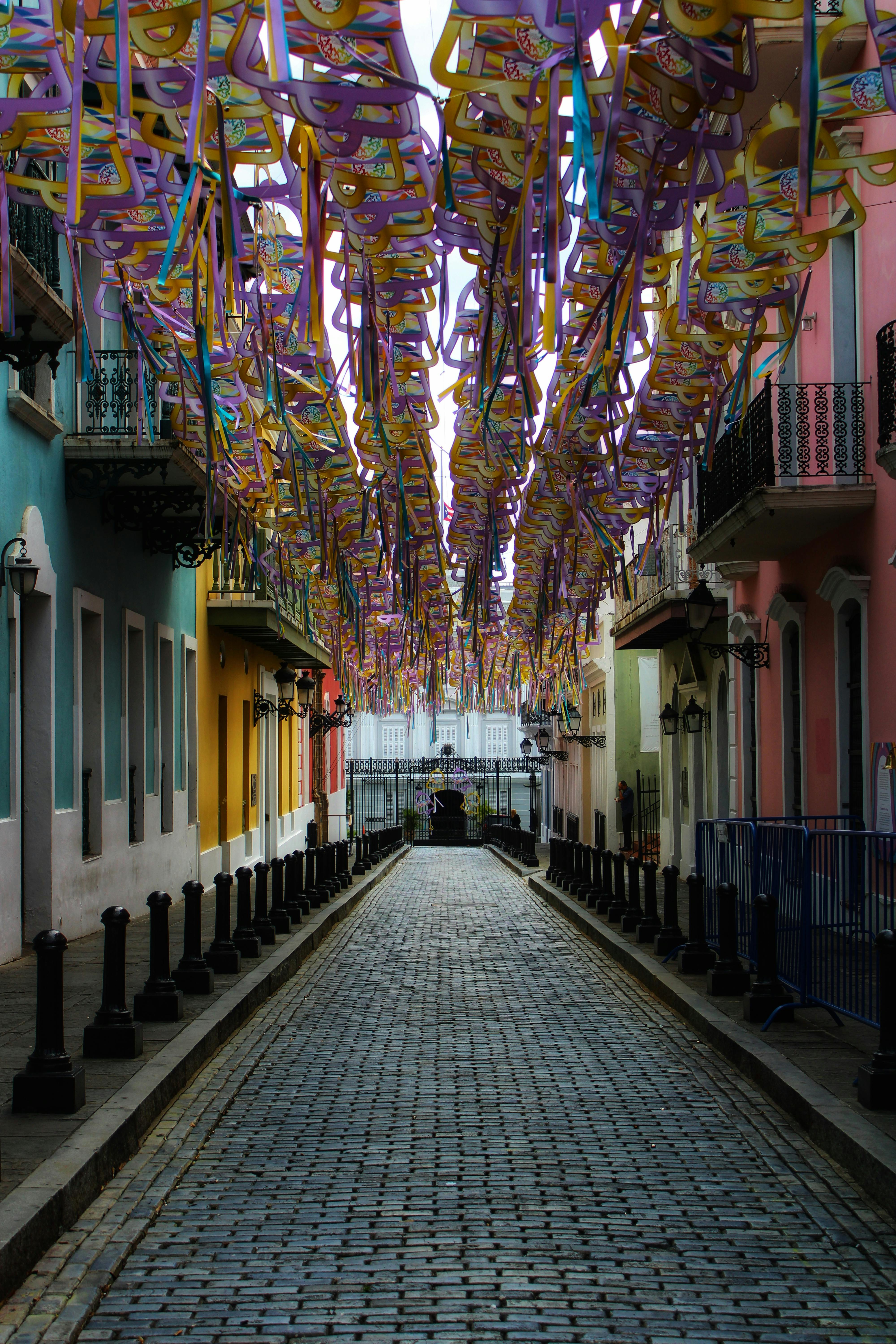 colorful cut out bells decoration above the alley in front of la fortaleza in san juan