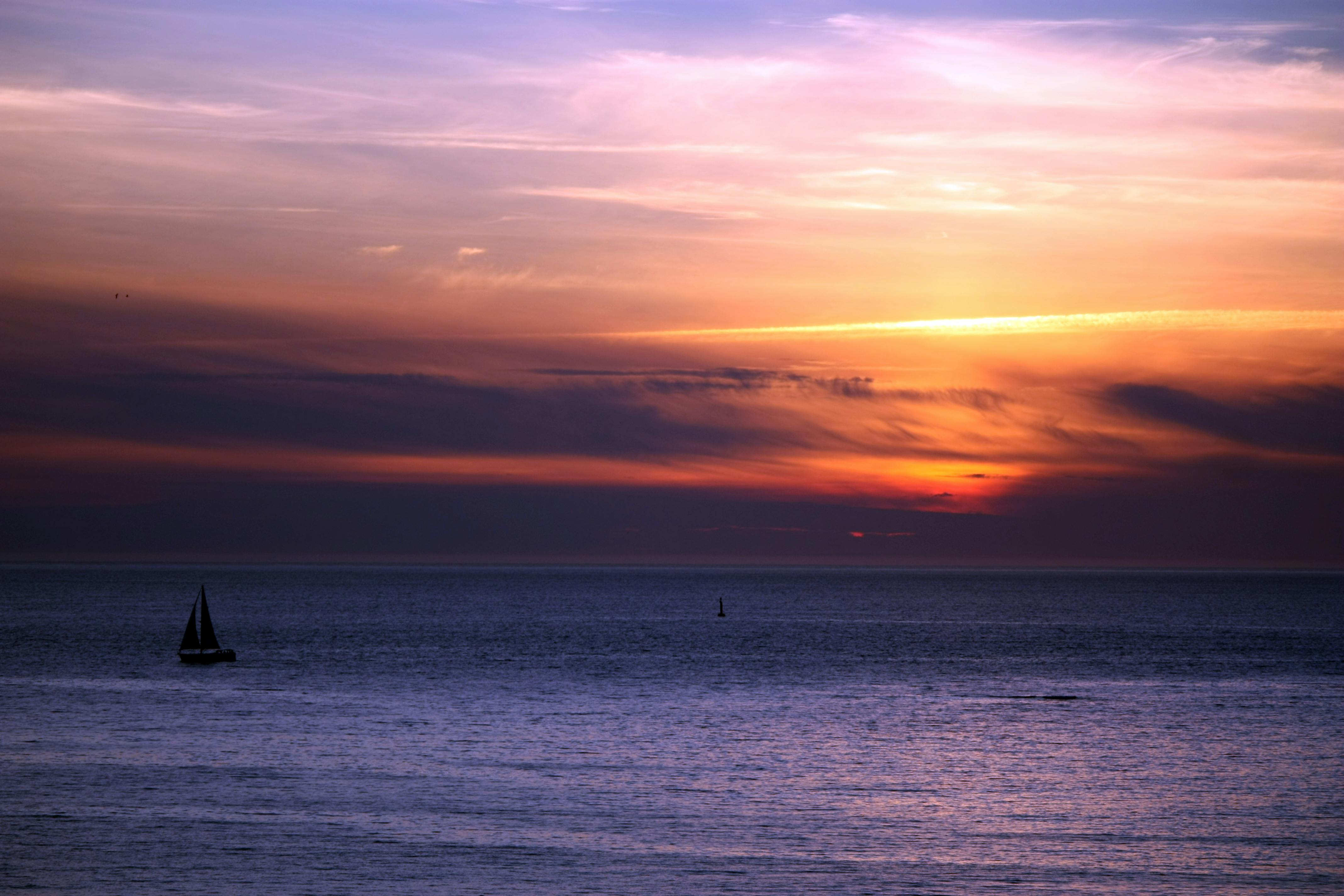A Ferry Sailing on Sea during Sunset · Free Stock Photo