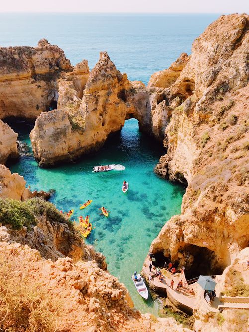 Free Stunning aerial view of cliffs and clear blue water at Lagos, Portugal, showcasing natural beauty. Stock Photo