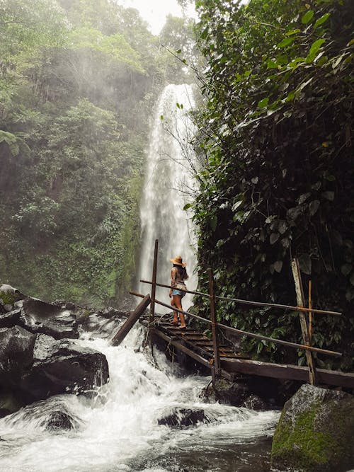 Woman Posing by Stream and Waterfall