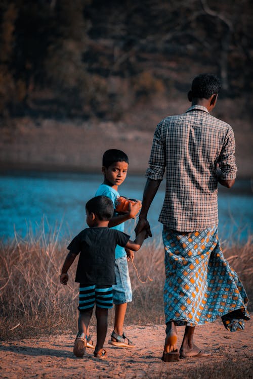 Free A Father Walking with His Sons Stock Photo