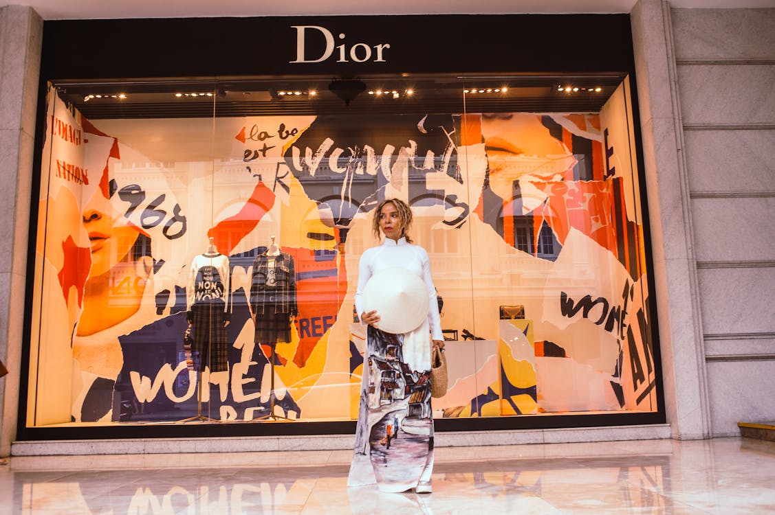 Free Woman Standing in Front of Dior Store Front Stock Photo