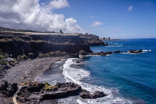 Free Discover the breathtaking black sand beach and dramatic cliffs of Santa Cruz de Tenerife, Spain. Stock Photo