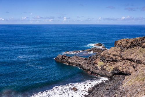 Free Stunning rocky coastline with clear blue skies and ocean in Puerto de la Cruz, Spain. Stock Photo