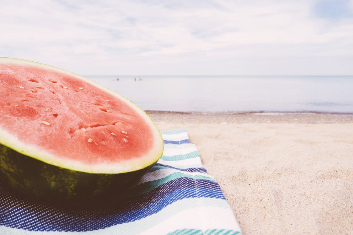 Free Sliced Water Melon on Textile Near Seashore Stock Photo