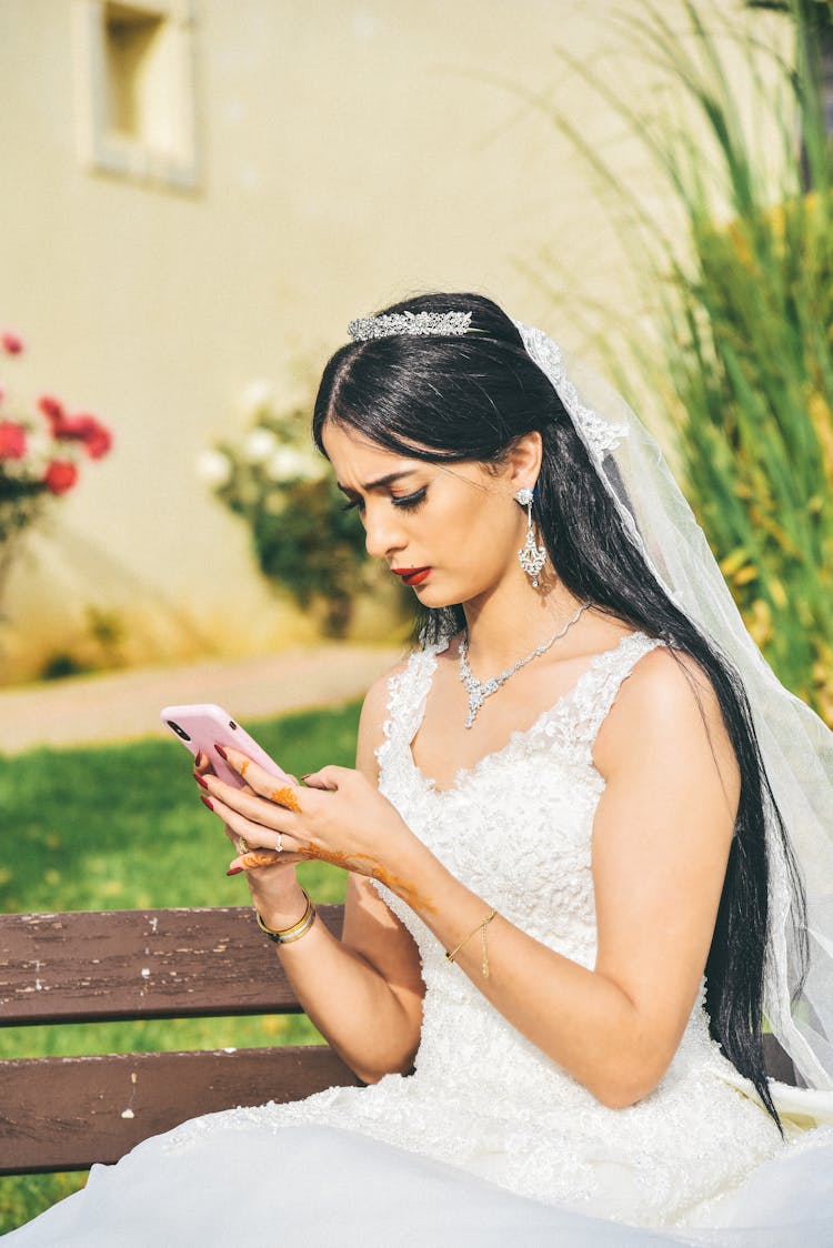 Woman In A Wedding Dress Using A Smartphone