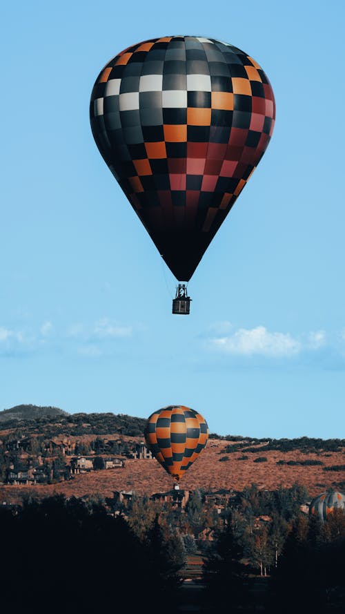 Two Hot Air Balloons Flying in the Blue Sky
