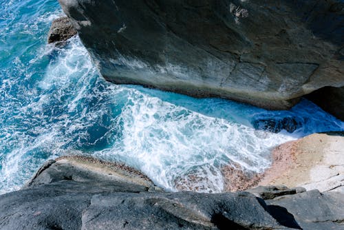 An Aerial Photography of an Ocean Between Rock Formations