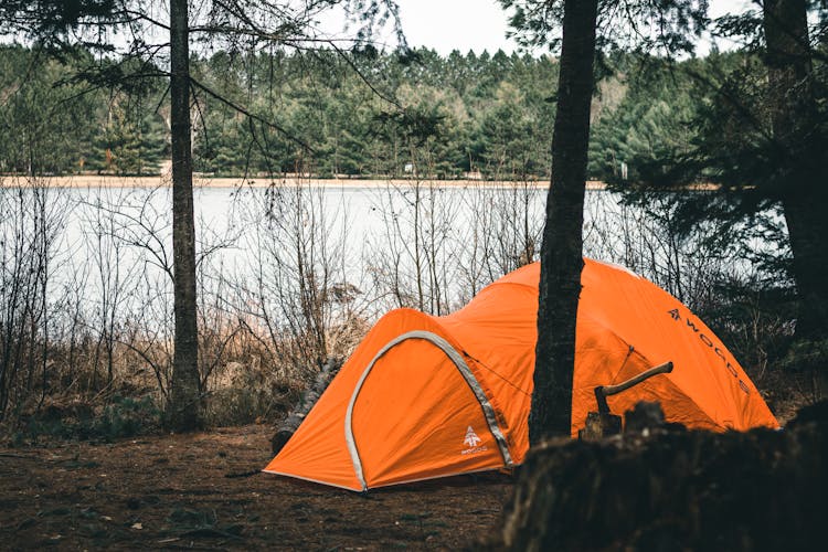 Orange Camping Tent Near A Lake