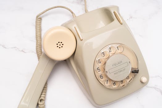 Classic beige rotary telephone with dial plate, embodying nostalgic technology.