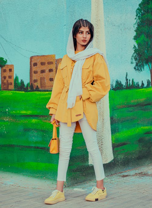 A Woman Wearing a Yellow Jacket and Scarf