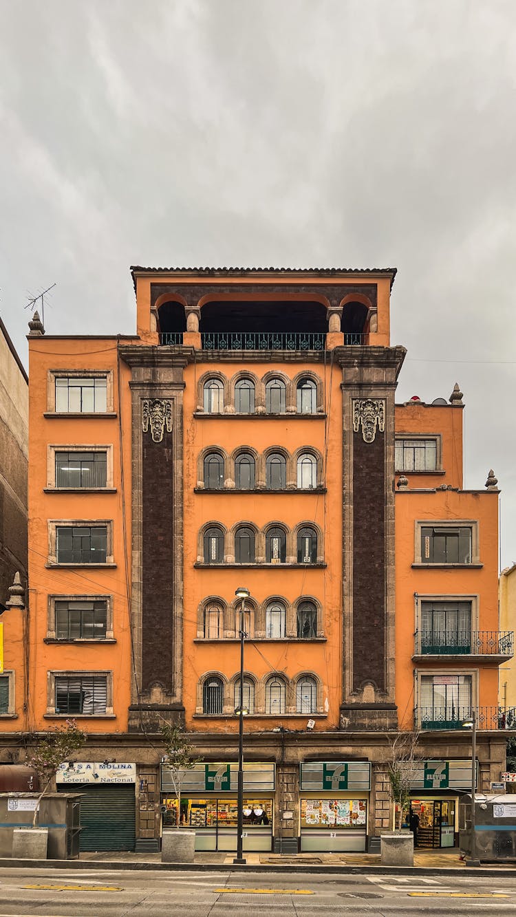 Orange Concrete Building With Arched Windows 