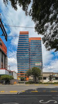 Contemporary skyscrapers against a bright sky, showcasing urban architecture.