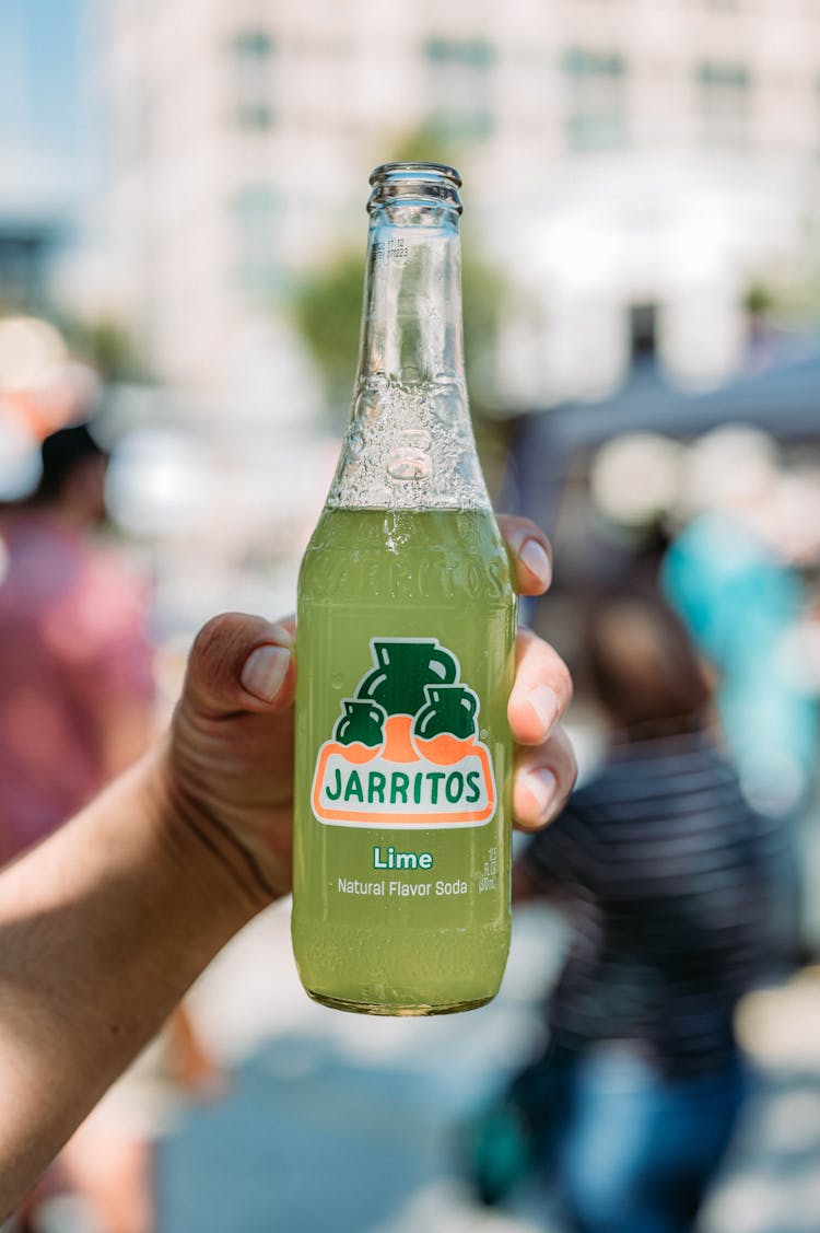 Close-up Of Holding A Bottle Of Lime Soda