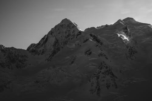 Grayscale Photo of a Snow-Covered Mountain