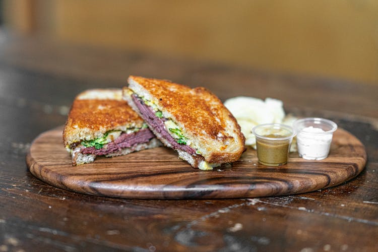 Dips On Plastic Containers And Sliced Sandwich